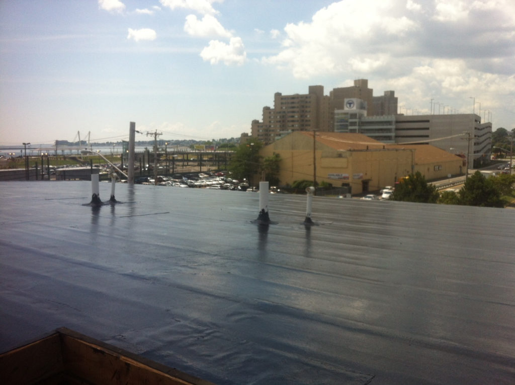 Flat roof coating on a Boston commercial building